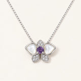 Orchid Bloom Mother of Pearl Necklace in silver with iridescent wings and purple spinel centre on a soft ivory background
