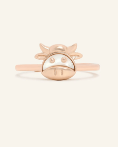 Close-up of the Ox Zodiac Ring in Mother of Pearl, resting on a warm linen background