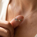 Papillon and Blossom butterfly necklace in rose gold with teal apatite, rhodolite garnet and chrome diopside worn at the collarbone