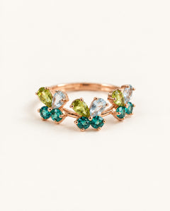 Papillon Butterfly Meadow Ring in rose gold with peridot and blue topaz butterflies on a light neutral background