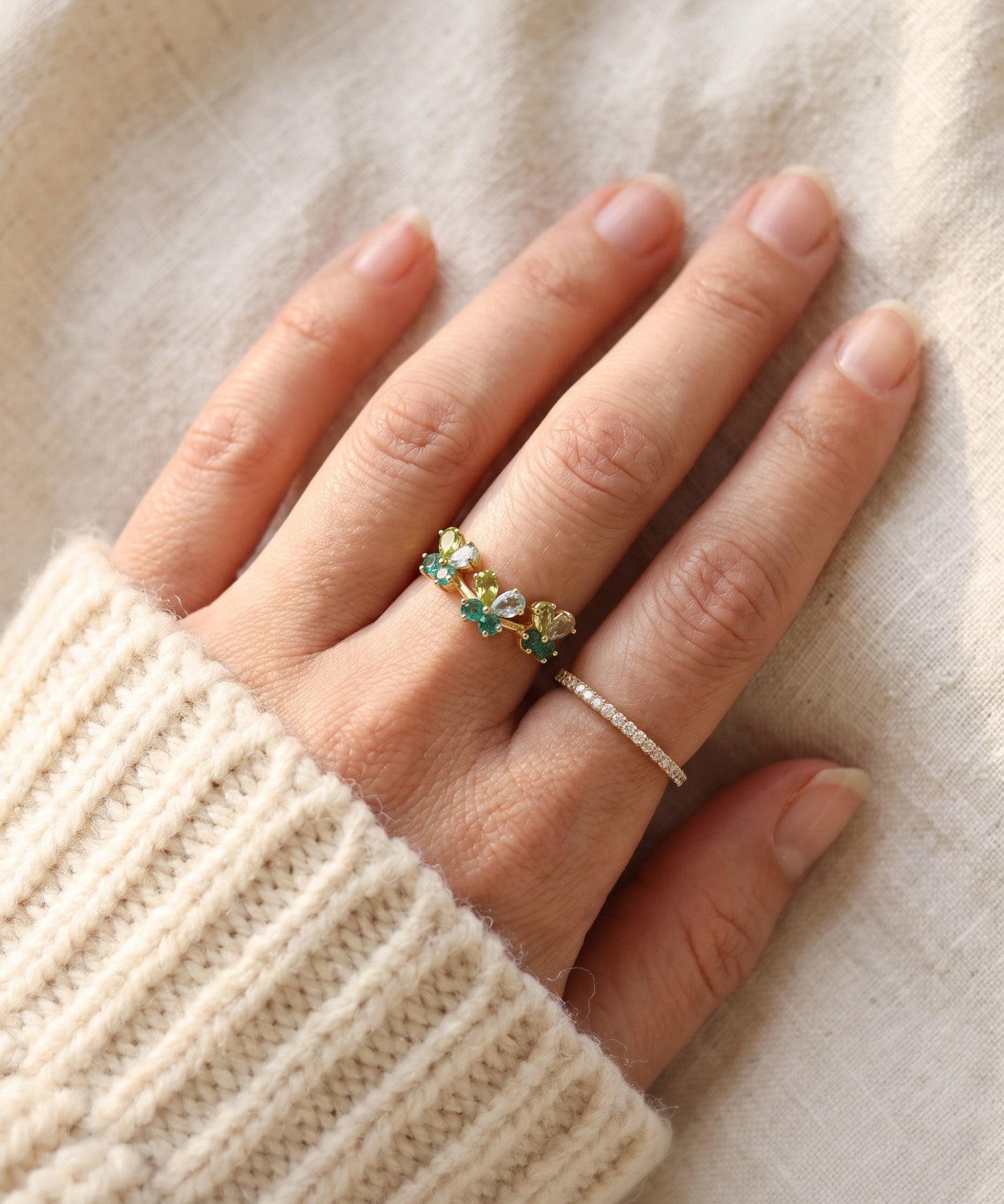 Papillon Butterfly Meadow Ring in rose gold with peridot and blue topaz butterflies worn on the hand