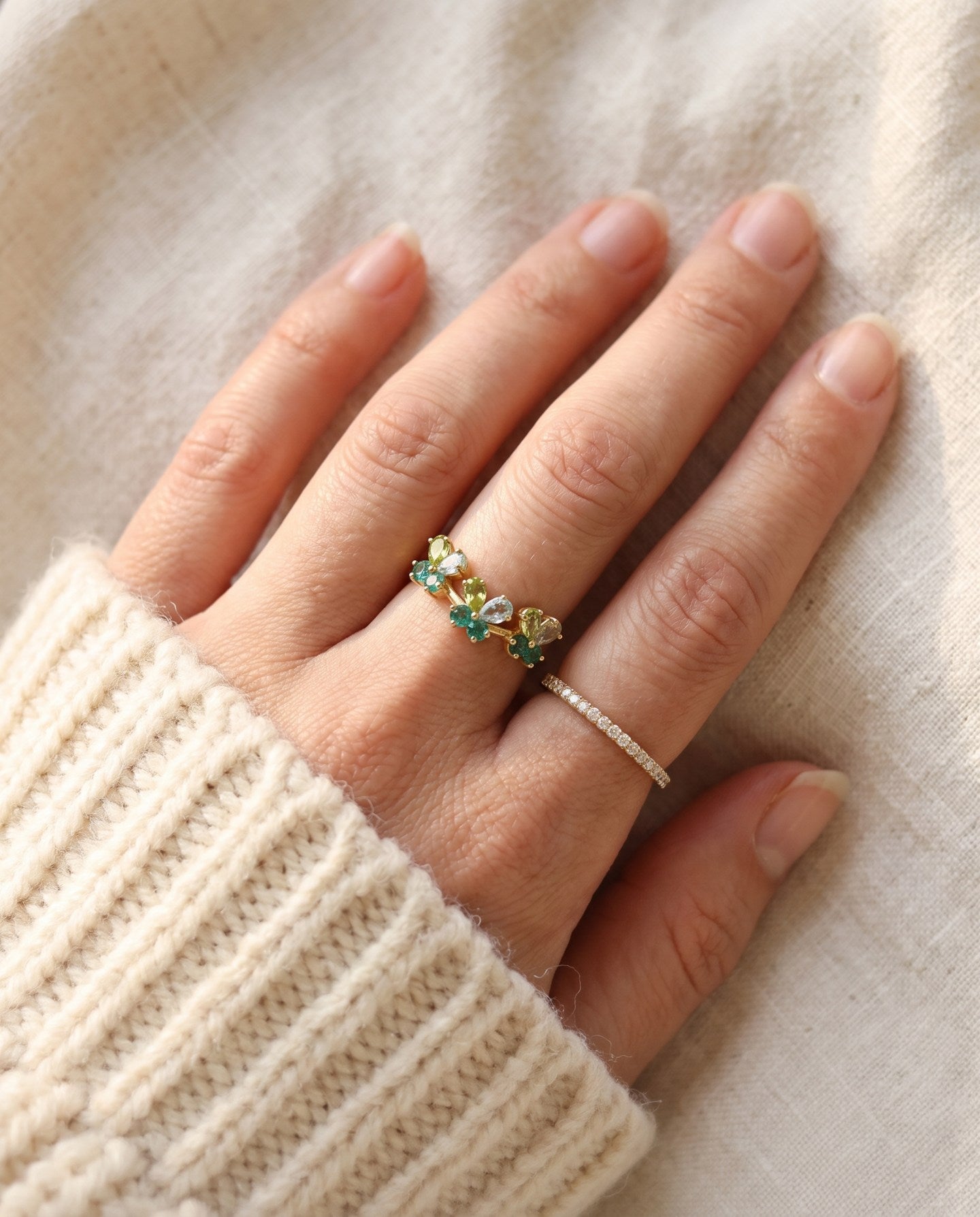 Papillon Butterfly Meadow Ring in rose gold with peridot and blue topaz butterflies worn on the hand