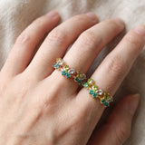 Papillon Butterfly Meadow Ring in rose gold with peridot and blue topaz butterflies worn on the hand