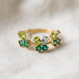 Papillon Butterfly Meadow Ring in yellow gold with peridot and blue topaz butterflies on a light neutral background