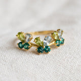 Papillon Butterfly Meadow Ring in yellow gold with peridot and blue topaz butterflies on a light neutral background