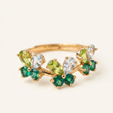 Papillon Butterfly Meadow Ring in yellow gold with peridot and blue topaz butterflies on a light neutral background