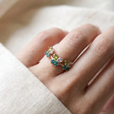 Papillon Butterfly Meadow Ring in yellow gold with peridot and blue topaz butterflies worn on the hand