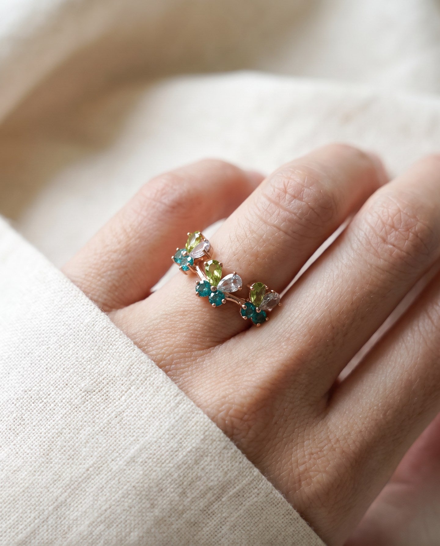 Papillon Butterfly Meadow Ring in yellow gold with peridot and blue topaz butterflies worn on the hand