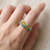 Papillon Butterfly Meadow Ring in yellow gold with peridot and blue topaz butterflies worn on the hand