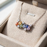 Prism Baguette Rainbow Sapphire Necklace in silver with six multicolour natural sapphires on a neutral ivory background