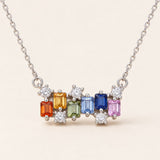 Prism Baguette Rainbow Sapphire Necklace in silver with six multicolour natural sapphires on a neutral ivory background