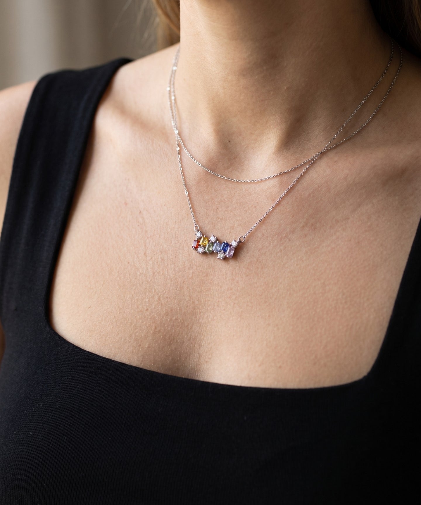 Prism Baguette Rainbow Sapphire Necklace in silver with six multicolour natural sapphires worn at the collarbone