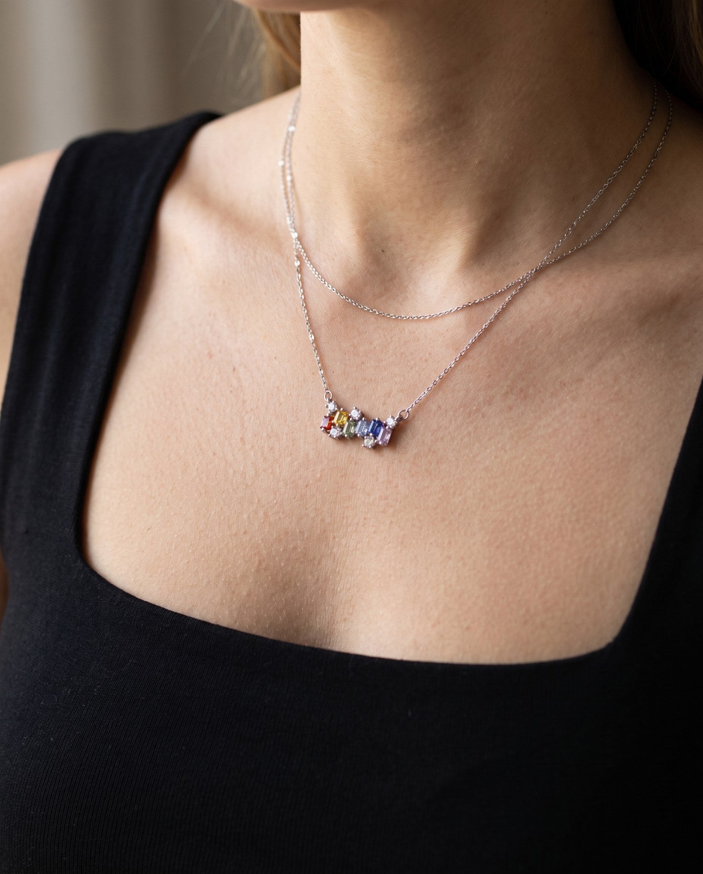 Prism Baguette Rainbow Sapphire Necklace in silver with six multicolour natural sapphires worn at the collarbone
