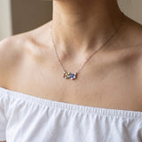 Prism Baguette Rainbow Sapphire Necklace in silver with six multicolour natural sapphires worn at the collarbone