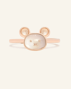 Close-up of the Rat Zodiac Ring in Mother of Pearl, resting on a warm linen background