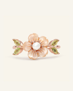 Sakura Blossom Ring, resting on a warm linen background