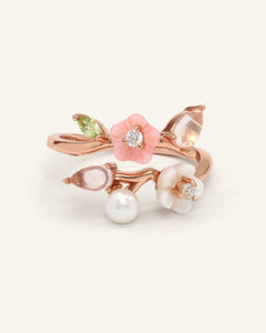 Sakura Symphony Ring, resting on a warm linen background