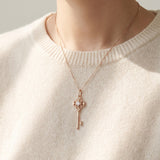 Memoir Grey Moissanite Key Necklace in rose gold, worn on a delicate chain in natural light