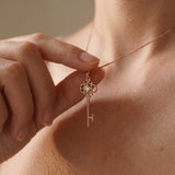 Memoir Grey Moissanite Key Necklace in rose gold, worn on a delicate chain in natural light