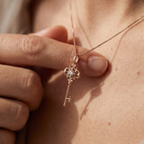 Memoir Grey Moissanite Key Necklace in rose gold, worn on a delicate chain in natural light