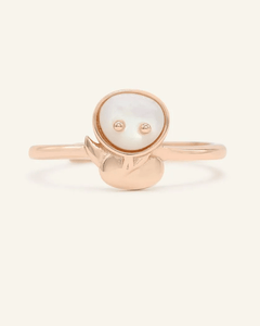 Close-up of the Snake Zodiac Ring in Mother of Pearl, resting on a warm linen background