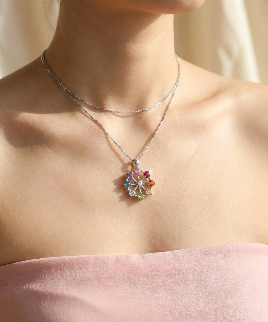 Spinning Ferris Wheel Necklace in yellow gold, showing the natural gemstones set around the wheel
