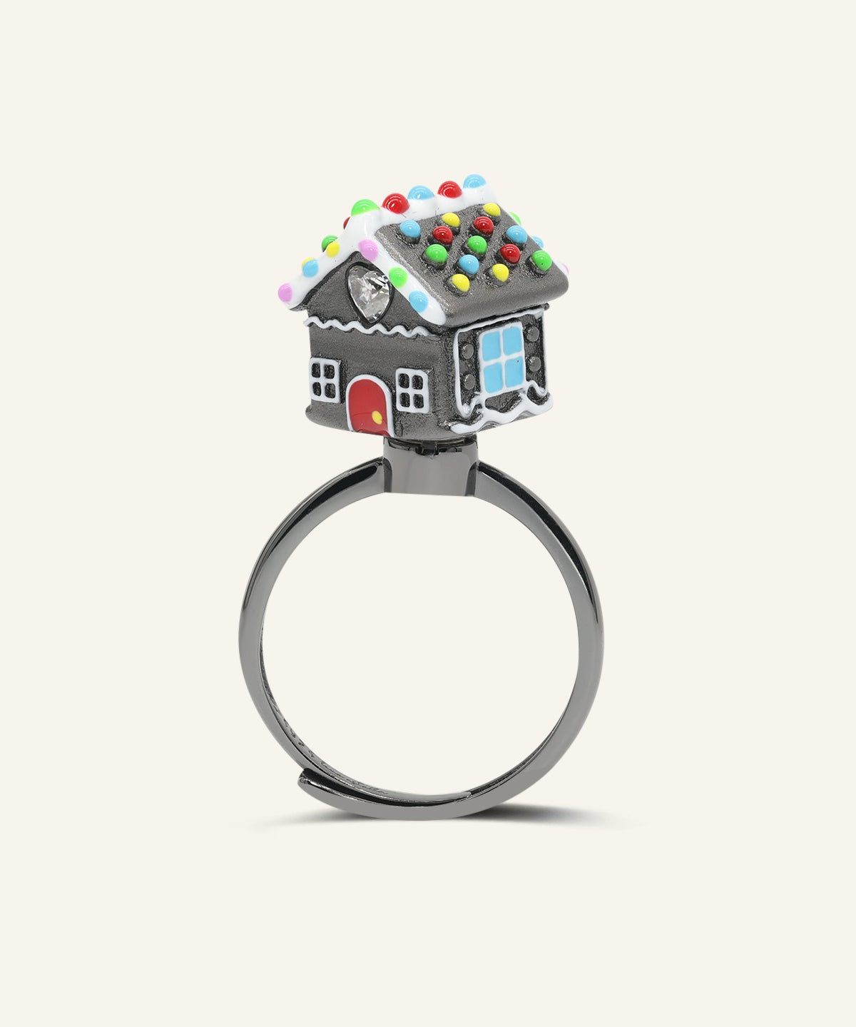 Spinning Gingerbread House Ring in black gold, angled view of the dark gingerbread house with colourful candy details