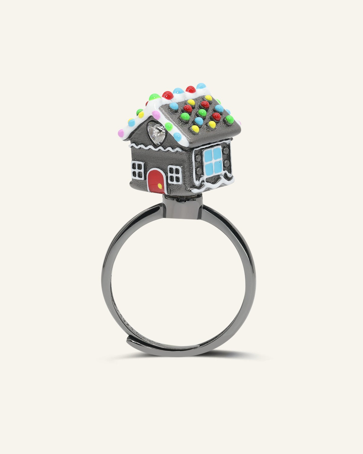 Spinning Gingerbread House Ring in black gold, angled view of the dark gingerbread house with colourful candy details