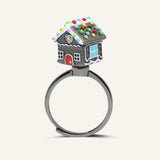 Spinning Gingerbread House Ring in black gold, angled view of the dark gingerbread house with colourful candy details