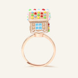 Spinning Gingerbread House Ring in rose gold, rear view showing the colourful candy roof and window