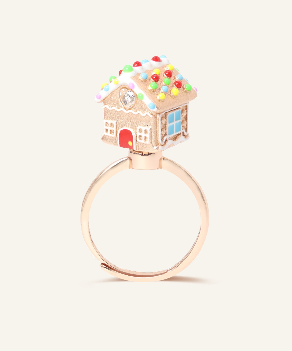 Spinning Gingerbread House Ring in rose gold, front view of the gingerbread house with candy-cane door and blue window