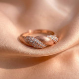 Sugar Sprinkled Croissant Ring in rose gold, resting on soft blush fabric in warm light