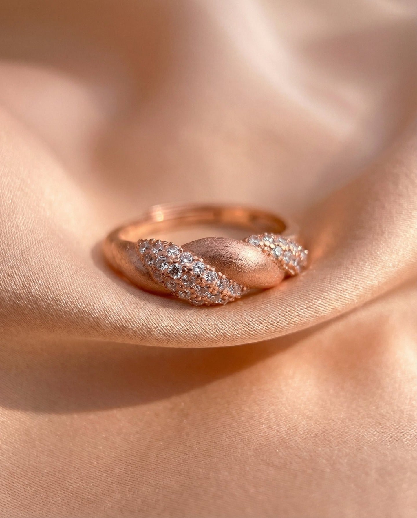 Sugar Sprinkled Croissant Ring in rose gold, resting on soft blush fabric in warm light