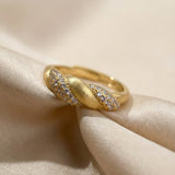 Sugar Sprinkled Croissant Ring in yellow gold, angled view on folded ivory fabric