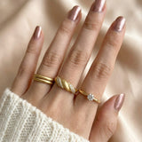 Sugar Sprinkled Croissant Ring in yellow gold, worn on a hand beside slim gold rings with an ivory knit sleeve