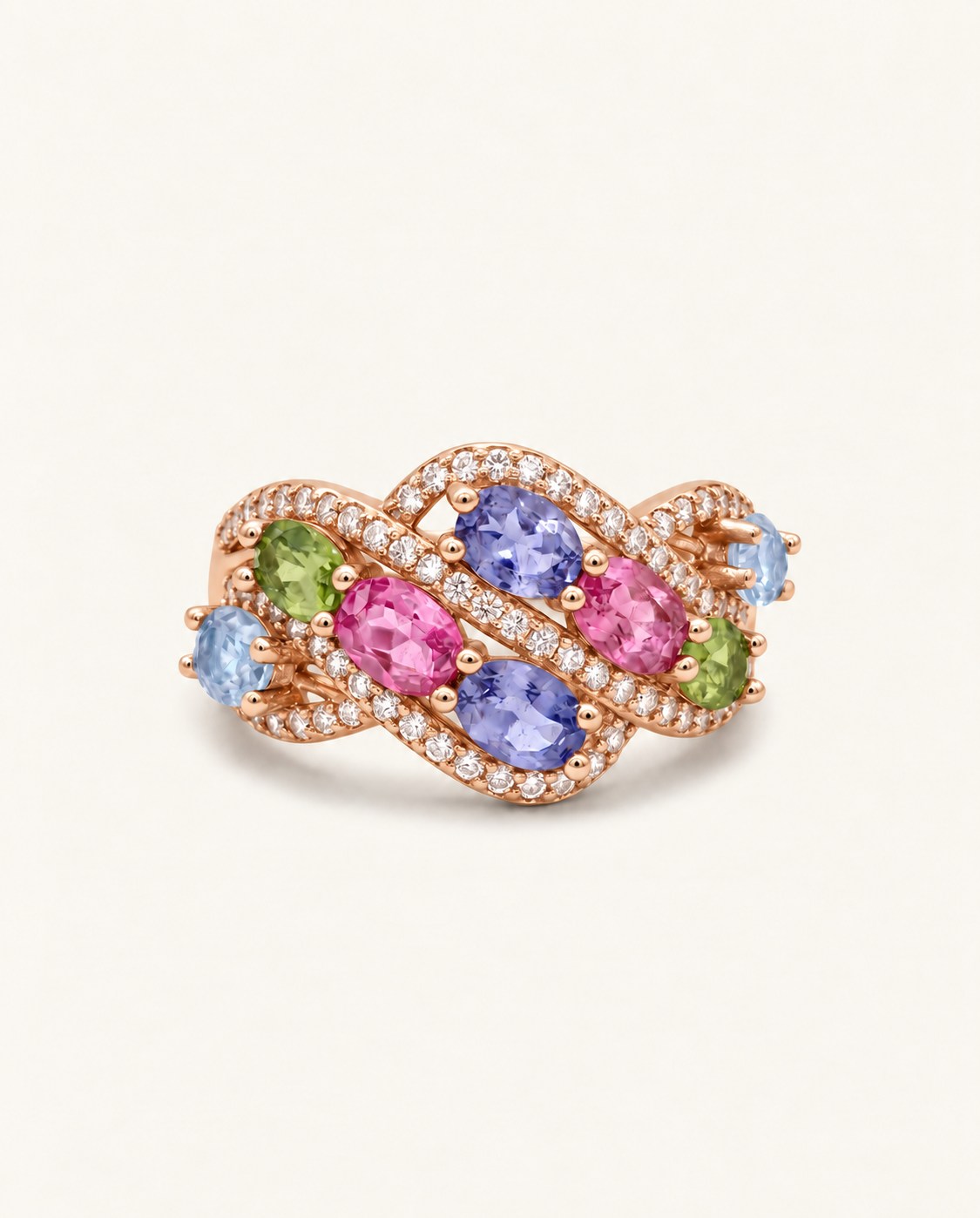 Symphony Wave Multi-Gemstone Ring in rose gold, on warm ivory with intertwined ribbons and colourful oval gemstones