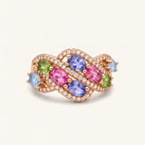 Symphony Wave Multi-Gemstone Ring in rose gold, on warm ivory with intertwined ribbons and colourful oval gemstones