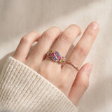 Symphony Wave Multi-Gemstone Ring in rose gold, worn on a hand in natural light