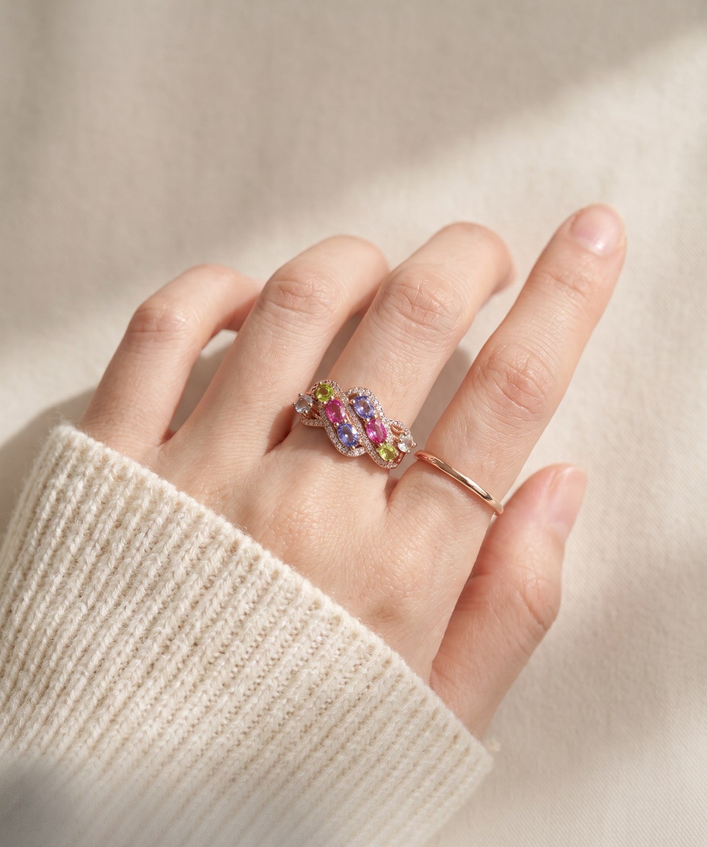 Symphony Wave Multi-Gemstone Ring in rose gold, worn on a hand in natural light