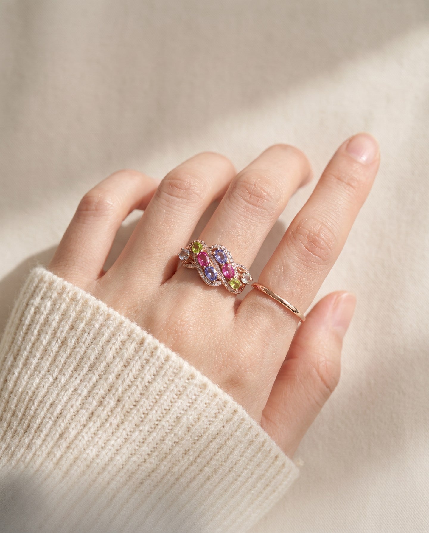Symphony Wave Multi-Gemstone Ring in rose gold, worn on a hand in natural light