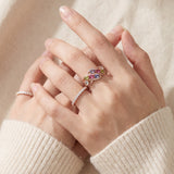 Symphony Wave Multi-Gemstone Ring in rose gold, worn on a hand in natural light