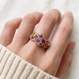 Symphony Wave Multi-Gemstone Ring in rose gold, worn on a hand in natural light