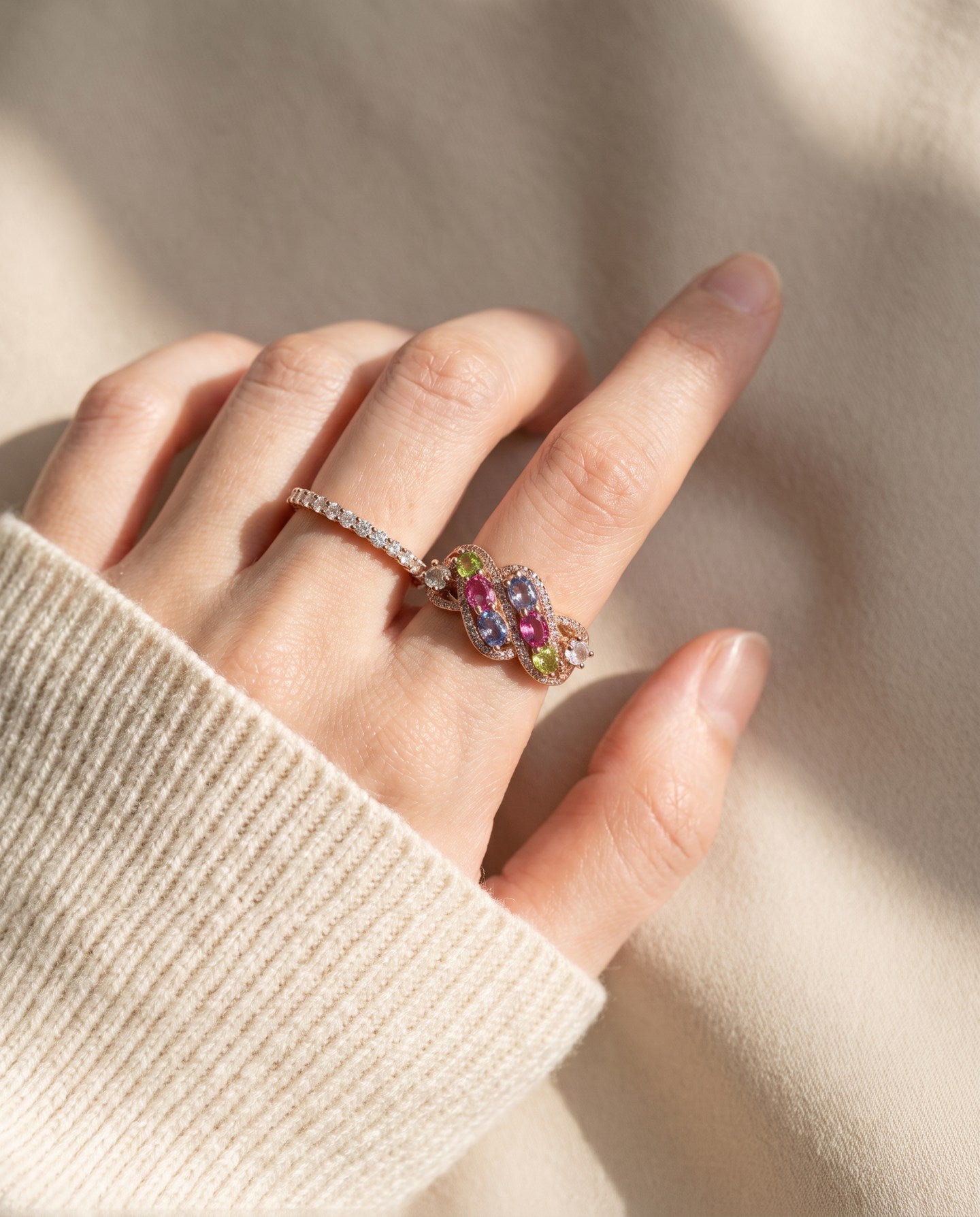 Symphony Wave Multi-Gemstone Ring in rose gold, worn on a hand in natural light