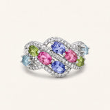 Symphony Wave Multi-Gemstone Ring in silver, on warm ivory with intertwined ribbons and colourful oval gemstones