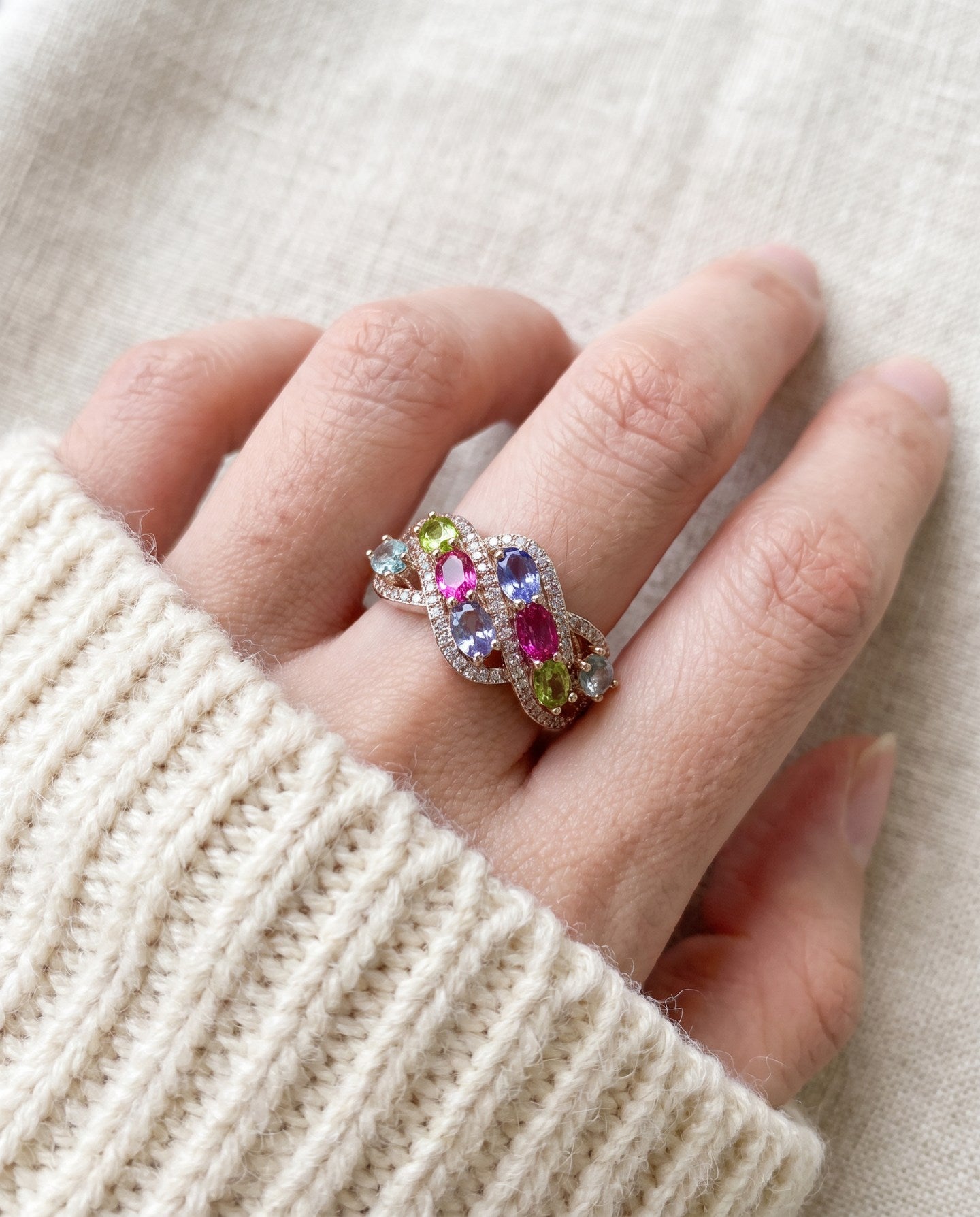 Symphony Wave Multi-Gemstone Ring in silver, worn on a hand in natural light