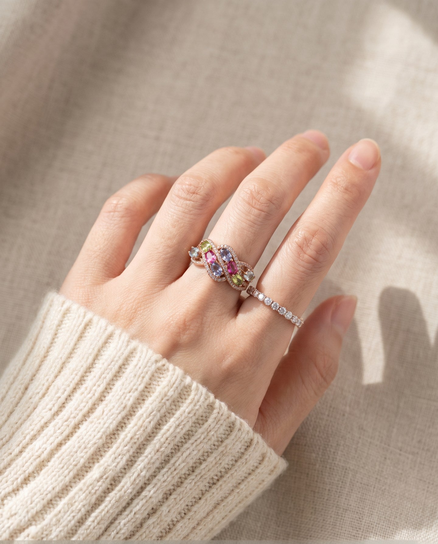 Symphony Wave Multi-Gemstone Ring in silver, worn on a hand in natural light