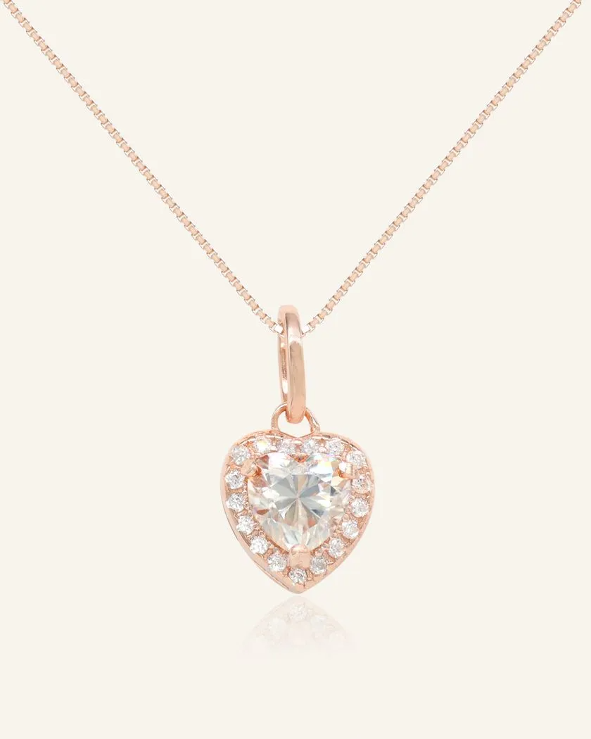white heart-shaped moissanite halo necklace in rose gold vermeil, featuring a sparkling moissanite centerpiece surrounded by a halo of cubic zirconias, set on a fine rose gold vermeil chain.